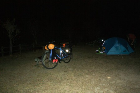 Bike and tent in the dark of Ehime camping ground near Matsuyama.