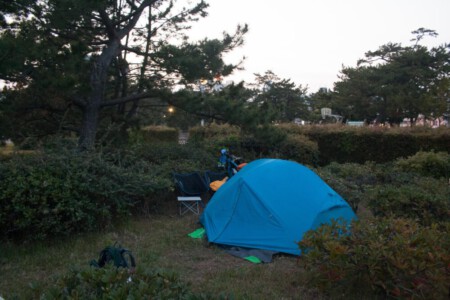 Camping spot with our tent in the beach park in Kobe.