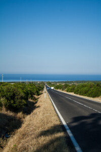Long road in the direction of the ocean in Sardinia.