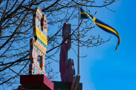 Some art in a park in Falkenberg - Swedish flag in the background.