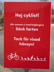 A sign at Naturum Getterön telling cyclists to slow down and think about others.