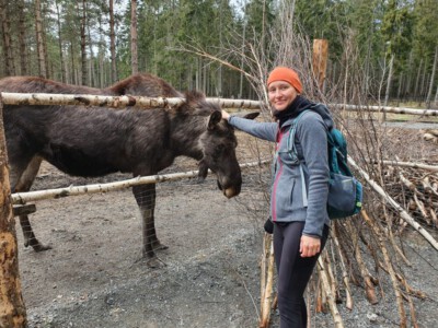 Alina pets a moose at the ranch in Ed.