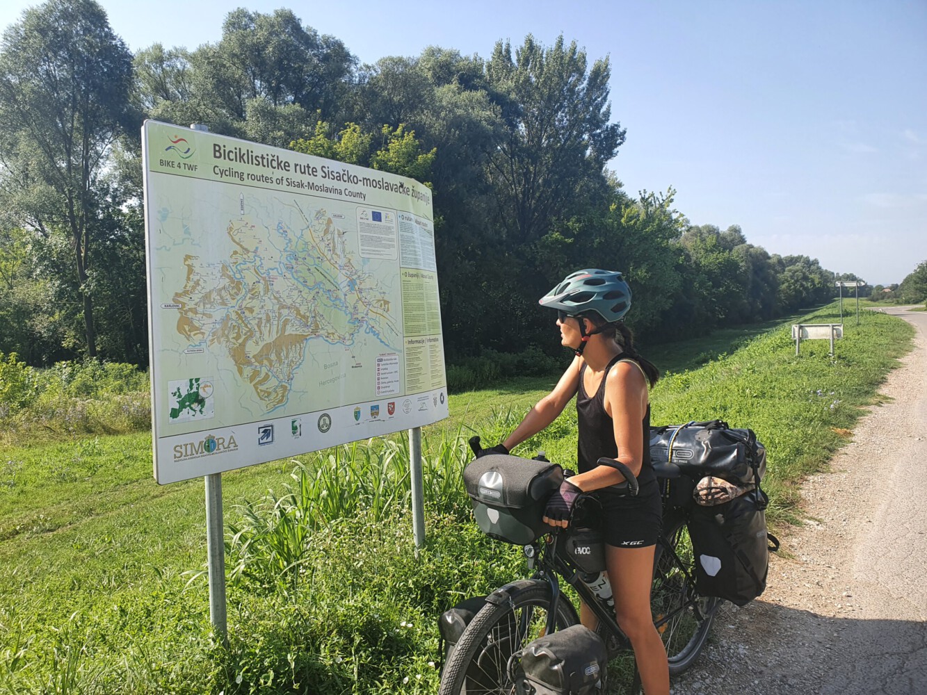 Alina at an information table with local bike tracks.